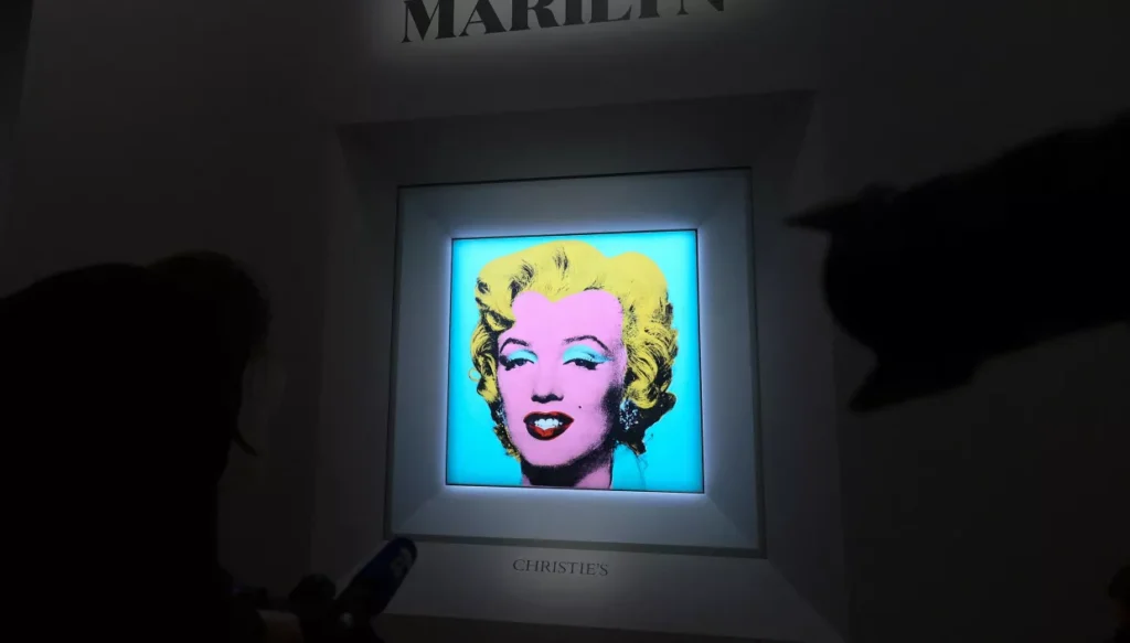 Andy Warhol's 'Shot Sage Blue Marilyn' painting during the announcement of its auction by Christie's Getty Images via AFP


